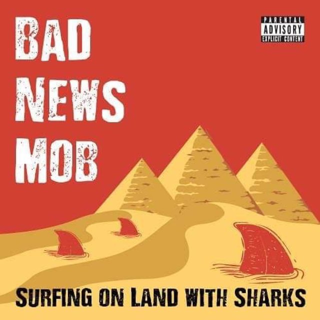 Surfing On Land With Sharks