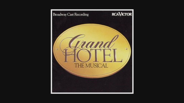 Checks into the Grand Hotel