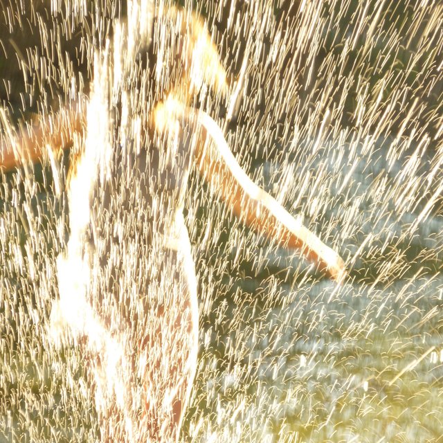 throwing sparks in the afternoon sun
